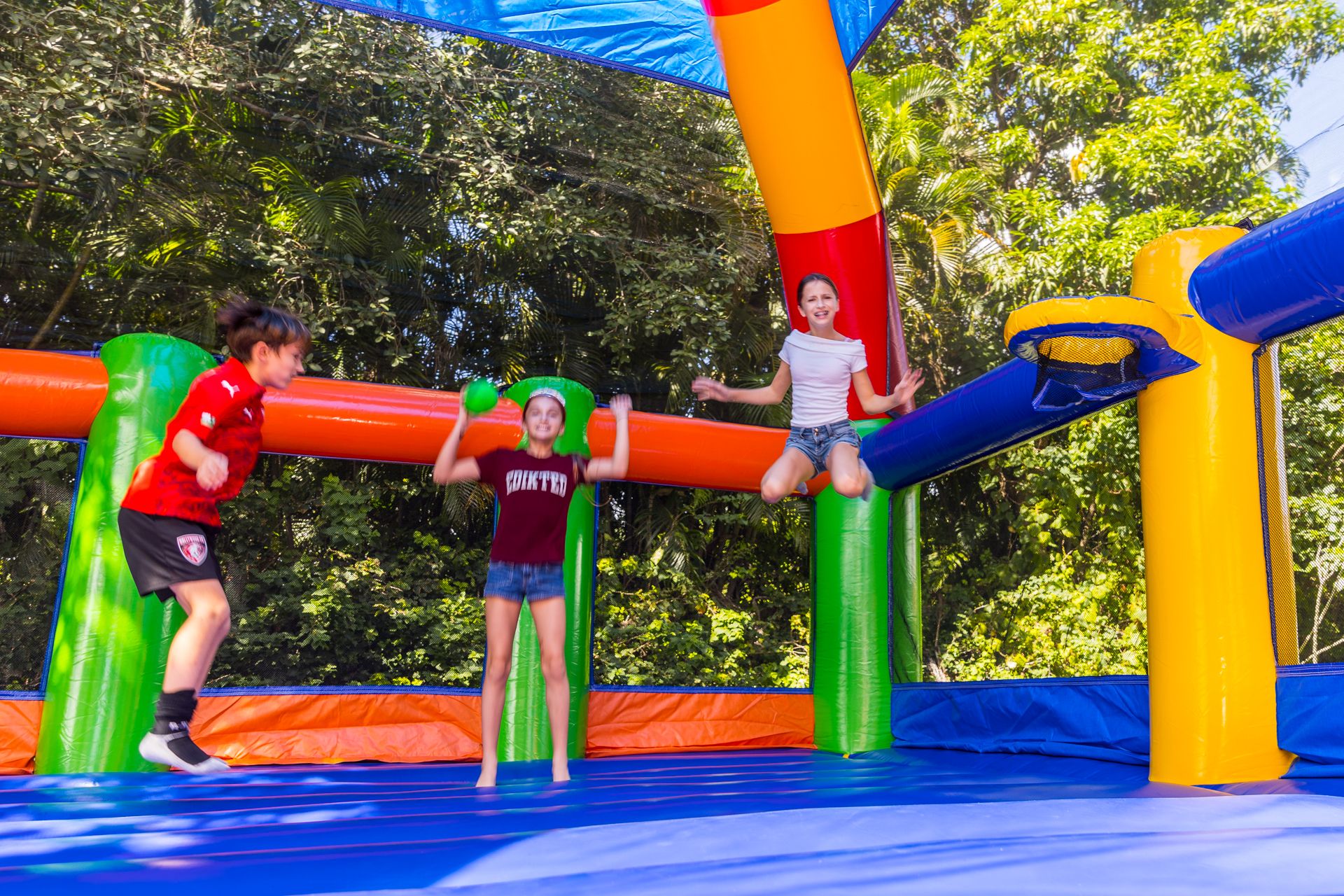 Kids in mid-jump on the trampoline